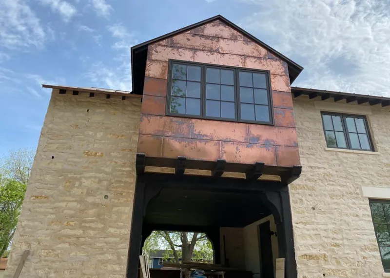 Copper metal panel facade on a stone building for Skylight Installation in Blaine