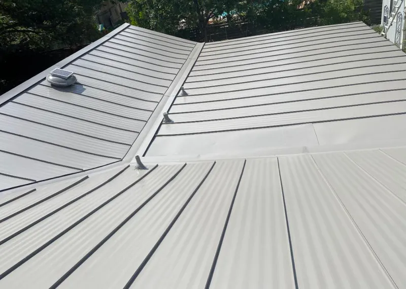 Solar attic fan installed on a metal roof for Roof Ventilation in Blaine